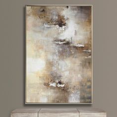 an abstract painting hangs on the wall above a white bench in front of a gray wall