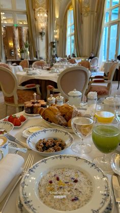 the table is set with many different types of food and drinks for two people to eat