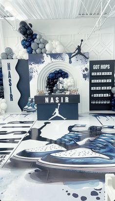 a basketball themed party with blue and white balloons, black and white tablecloths and decorations