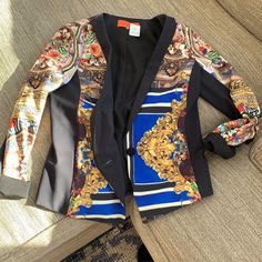 This Jacket Is Begging For Some Holiday Action Wear Or Gift This New Elegant Collarless One Button Jacket From Clover Canyon Will Look Equally Smashing Over Distressed Jeans As With Black Leather Leggings. Gorgeous Richly Colored Prints. Sleek Black Lining. Side Panels Are Black Which Creates A Stunning Slimming Effect Polished Perfection. The Finishing Touch To Even The Simplest Outfit. 22” Long, Sleeves 23.” But Can Also Be Cuffed Or Rolled, Shoulders 15”, 16” Flat Under Arm, Seam To Seam. New Perfect New Condition. Chic Multicolor Workwear Outerwear, Designer Multicolor Long Sleeve Blazer, Designer Multicolor Blazer For Work, Multicolor Formal Outerwear For Fall, Designer Blue Blazer, Designer Blue Long Sleeve Blazer, Elegant Multicolor Long Sleeve Outerwear, Rolled Shoulders, Black Leather Leggings