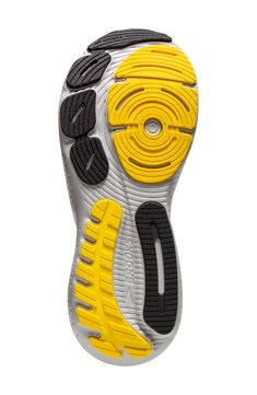 the sole of a shoe with yellow and black accents on it, against a white background