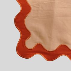 an orange and beige placemat with scalloped edges