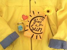 a yellow jacket with a sun book, jar of jelly and a flower on it