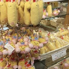 many stuffed animals are on display in a store with tags hanging from the hooks and key chains