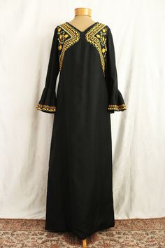 "Absolutely gorgeous vintage embroidered black wool maxi dress. Featuring flounced bell sleeves embellished with the same embroidery as on the bodice. The soutache style embroidery is vibrant yellow and orange with swirls and flowers. The neckline comes to a v-shape and there is a metal Para zipper back that goes about halfway down the back of the dress with a hook and eye closure at the neck. The body is lined in black satin. Sleeves are unlined. No label. Material: Wool/Satin Era: Late 60's - Mid 70's Measurements Bust: 36\" Waist: 34\" Hip: 38\" Sleeve Length: 22\" Shoulder to Shoulder: 15\" Length: 54\" Estimated modern size: Small - Medium. Please refer to measurements. The fabric does not stretch. Condition In excellent vintage condition. Some slight wear to the embroidery, but doesn Fitted Embroidered Maxi Dress For Fall, Wool Maxi Dress, Satin Sleeves, Satin Noir, Disco Dress, Maxi Dress With Sleeves, Vintage 60s, Black Wool, Dress Clothes For Women