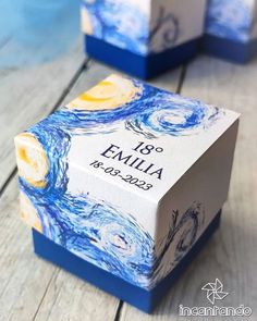 the box is decorated with blue and yellow swirls on it's sides, which are printed with an image of the starry night sky