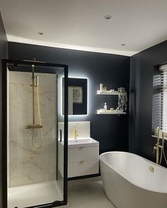 Bathroom with black walls, freestanding bath, white wall hung vanity and gold detailing. Freestanding Bath Taps, Face Mirrors, Bathroom Inspiration Modern, Gold Bathroom, Vanity Unit