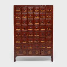 an old wooden cabinet with many drawers