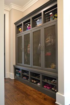 an image of a room with some shoes on the floor and a large cabinet in front of it