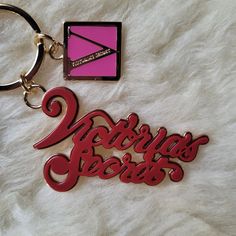 a pink and red keychain with the words victoria's secrets on it