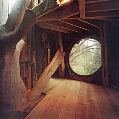 the inside of a wooden structure with a circular window