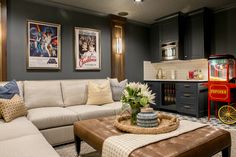 a living room filled with furniture and pictures on the wall