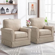 two striped chairs sitting next to each other in a living room