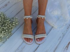 Comfort is key with these cute embellished wedding sandals that are perfect for a beach wedding. A cushioned footbed means you can wear them all day and an ankle strap means they won't get lost in the sand. How cute are the pearls and diamantes! All Pelino shoes are made to ensure the highest level of comfort throughout the day. Full sizes only ** If you have half the size, go UP to the nearest full size ** If you are unsure of your size, please contact me so I can assist you. ★ More wedding san Bridal Shower Pearl Embellished Ankle Strap Sandals, White Embellished Flat Heel Sandals, Wedding Sandals With Rhinestones And Single Toe Strap, Flat Heel Sandals With Rhinestones For Wedding, Flat Heel Rhinestone Sandals For Weddings, Summer Wedding Embellished Sandals, Adjustable Flat Sandals For Wedding, Embellished Wedding Sandals With Open Toe, Summer Wedding Shoes Silver Embellished