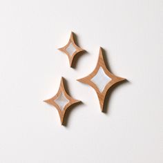 three wooden shapes on a white surface