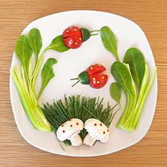 a white plate topped with green vegetables and ladybugs