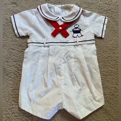 Vintage Lord & Taylor One Piece White Nautical Sailor 12 M Romper Jon Jon Short - Outfit Is In Pristine Condition With No Signs Of Wear Or Flaws At All. In New Without Tags Condition. Short-All Comes With Attached Belt And Red Necktie. It Also Has Navy Blue Piping Along The Collar, Cuffs, And Belt As Well As A Small Navy And Red Embroidered Sailor On The Chest. Outfit Has All Original Buttons And The Metal Crotch Snaps Are In Perfect Condition Fitted White Nautical Tops, White Fitted Nautical Tops, Jon Jon, Taylor White, Walker Boots, Pajama Shirt, Fit N Flare Dress, Rain And Snow Boots, Kids Bottoms