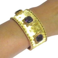 Beautiful 18k gold cuff with 3 10.5mm x 10.3mm amethyst gemstones DESIGNER: Buccellati MATERIAL: 18K Gold GEMSTONE: Amethyst DIMENSIONS: Bracelet will fit up to 6" wrist and is 28mm WEIGHT: 61.2g MARKED/TESTED: Buccellati,750 CONDITION: Estate PRODUCT ID: IN804 Luxury Yellow Gold Cuff Bracelet With Gemstone, Luxury Yellow Gold Amethyst Bracelets, Formal Yellow Gold Cuff Bracelet With Gemstone, Elegant Purple Gemstone Cuff Bracelet, Luxury Gold Amethyst Bracelets, Luxury Amethyst Bracelets For Formal Occasions, Gold Amethyst Bracelets For Formal Occasions, Gold Bracelet Cuff, Gold Cuffs