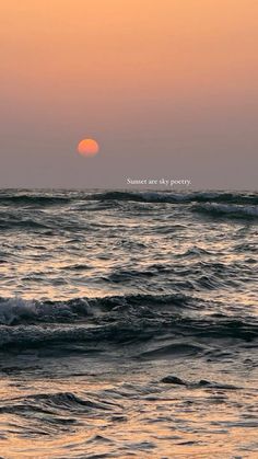 the sun is setting over the ocean with waves in front of it and an inscription on the horizon