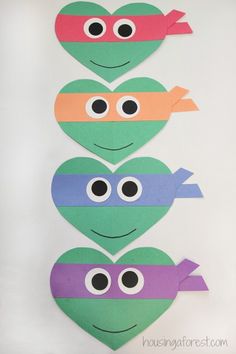 three heart shaped paper cut outs with eyes