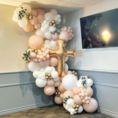 a cross made out of balloons in a room