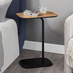 a small wooden table with a book on it