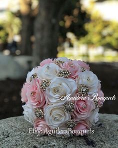 a bridal bouquet sitting on top of a rock