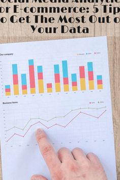 a hand pointing at a social media roi chart on top of a piece of paper