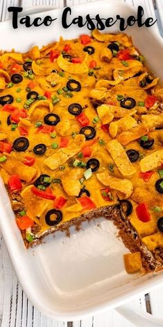 a casserole dish with tortilla chips and black olives on top