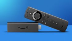 an amazon fire tv remote sitting on top of a blue surface with the amazon logo above it