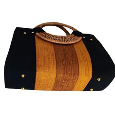 If you love elegant and classy handbags and love making a statement then this bag is for you! With sturdy and gorgeous cane handles and a stunning combination of colors from the Fugu fabric, the bag is practically royalty. The Fugu or Smock fabric is a luxury native fabric worn mostly by the royals of the Northern Tribes of Ghana. This bag also comes with an inner pocket with a zip fastening and provides lots of space, it's even big enough for a small laptop! As if that was not awesome enough, w Elegant Brown Beach Bag, Elegant Brown Beach Bag With Double Handle, Elegant Brown Double Handle Beach Bag, Elegant Brown Rectangular Beach Bag, Elegant Bag With Bamboo Handle For Vacation, Elegant Vacation Bag With Bamboo Handle, Elegant Brown Shoulder Beach Bag, Elegant Brown Rectangular Canvas Bag, Elegant Brown Handheld Beach Bag