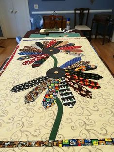 the table is covered with an intricately designed quilt