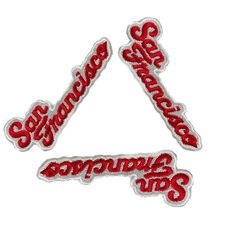 two red embroidered stickers with the words scorpions on them, and an arrow