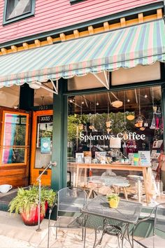 an outside view of a coffee shop with tables and chairs