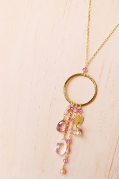 Free shipping on our lush pink clear quartz and pink tourmaline gemstone necklace for women. Made with multiple strands of different gemstone combinations dangling from a 14k gold plated hoop. Necklace is lightweight with a spring ring clasp. 16 inches long - can be extended up to 2 more inches for up to 18 inches in length. Made of 14k gold plated fine Italian silver. Stamped for authenticity. Our unique plating technique makes our gold plated jewelry tarnish resistant. All of our earrings and Pink Tourmaline Dangle Jewelry, Pink Tourmaline Bohemian Jewelry, Pink Pendant Necklace With Dangling Charms, Pink Dangle Necklaces With Gemstones, Gemstone Combinations, Hoop Necklace, Gold Circle Necklace, Silver Top, Rose Quartz Necklace