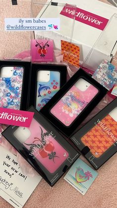 several cell phones are in their boxes on the floor next to some cards and tags