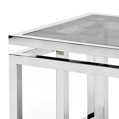 a glass table with metal legs and a square top on an isolated white background,