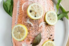 salmon with lemons and herbs on a plate