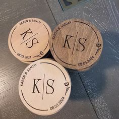 three personalized wooden coasters sitting on top of a table