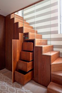 the stairs are made of wood and have drawers under them on each side for storage