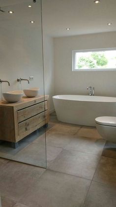 a bathroom with a toilet, sink and bathtub in the middle of it's walls