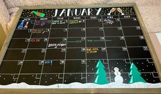 a calendar with a snowman and trees on it