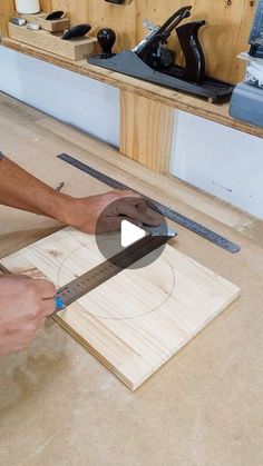 a man working on a piece of wood with a pair of scissors in his hand