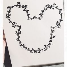 a drawing of a heart with vines and hearts drawn on it