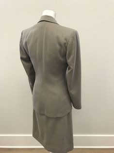 "I love suits from this era because they have such great vintage details. The silhouette and fabric from the late 1940s/early 1950s are are fantastic. The gorgeous scalloped double layer pocket flaps are my favorite detail but the tan dome buttons connected by a silver chain for the closure is a close second. The collar and lapel as well as jacket hem are curved and accented with pick stitching along the edges as well as on the double pocket flaps. Bound buttonholes. The skirt has inverted darts Vintage Fitted Skirt Suit With Notch Lapel, Tailored Classic Skirt Suit, Retro Fitted Skirt Suit For Tailoring, Classic Fitted Skirt Suit With Pockets, Fitted Vintage Suits For Workwear, Vintage Fitted Skirt Suit For Formal Occasions, Vintage Notch Lapel Skirt Suit For Work, Classic Fitted Beige Skirt Suit, Classic Beige Fitted Skirt Suit