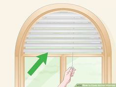 an open window with the blinds closed and hand pointing at something in front of it