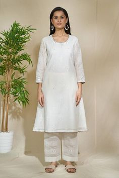 White kurta with all over floral blossom block print embellished by mirrorwork. Comes with pant and dupatta. - Aza Fashions Spring Wedding Sharara In Mulmul, Spring Wedding Mulmul Sharara, Traditional Spring Sharara With Cutdana, Traditional Cutdana Sharara For Spring, Spring Traditional Cotton Silk Palazzo Set, Traditional Cotton Silk Sharara For Spring, Spring Cotton Traditional Wear With Gota Work, Spring Traditional Cotton Wear With Gota Work, Transitional Off-white Cotton Set