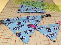 three pennants are laying on a cutting board and ready to be sewn together