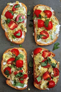 four slices of bread with tomatoes and other toppings