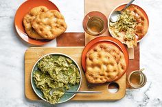 an image of food on the table with spoons and plates in front of it